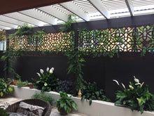 Our outdoor stainless privacy screen detail in a garden setting.