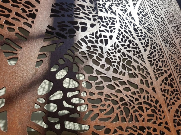 Macro shot of precise laser-cut perforations on hairline finish.