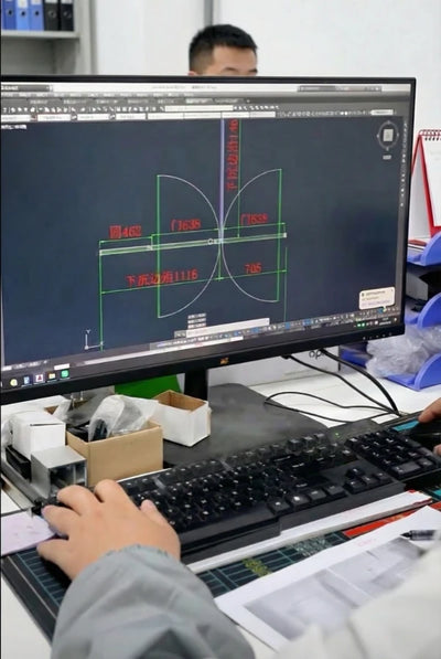 Engineering team reviewing CAD shop drawings for custom metal fabrication projects.