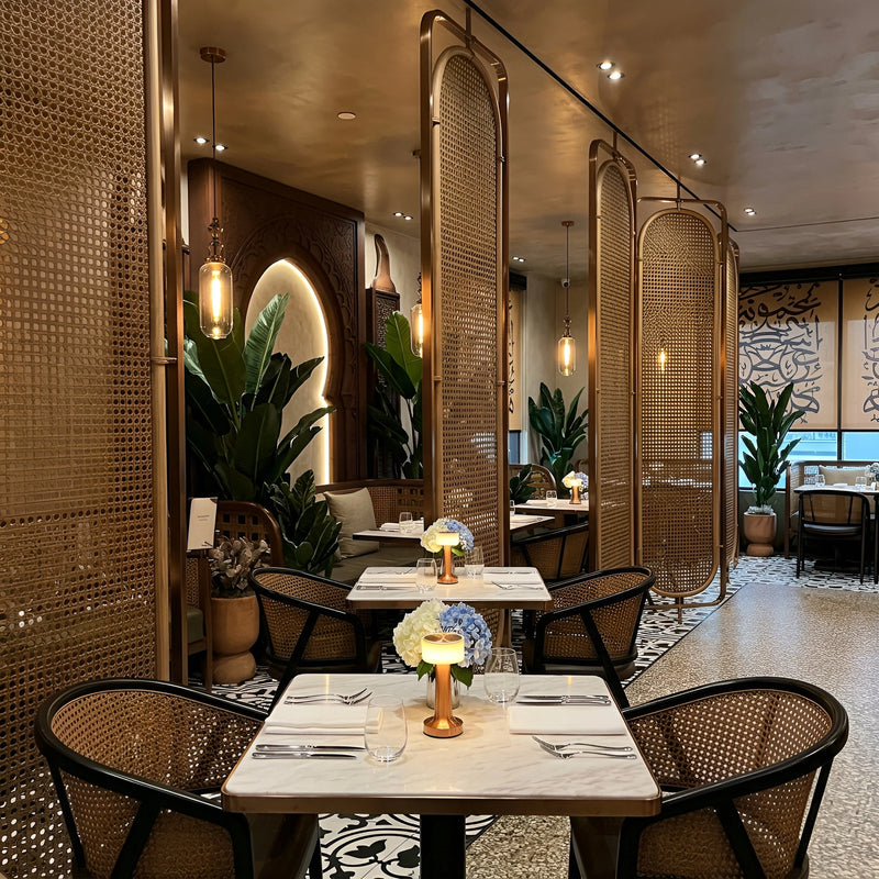 Fine dining room zoned by bronze laser-cut stainless screens between banquettes — visualization
